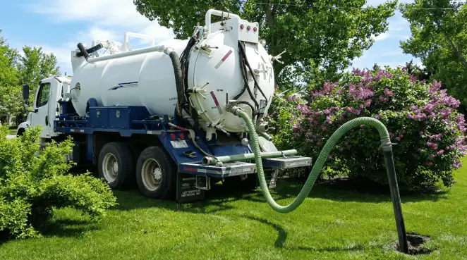 Professional vacuum truck performing residential drainage and septic maintenance in Columbus, GA