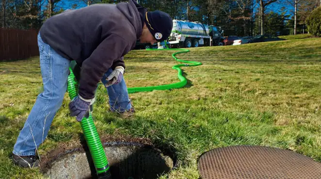 Service technician performing residential septic pumping and drainage maintenance in Columbus, GA